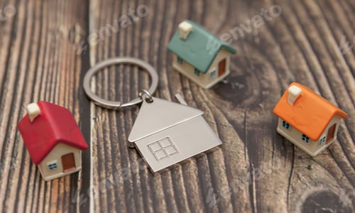 Preview: Several colored houses and a key chain on a wooden background.