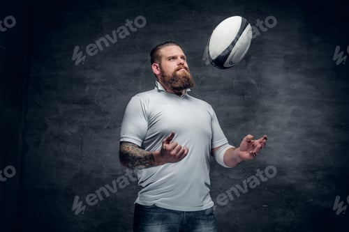 Preview: Portrait of bearded rugby player with tattoos on his arms