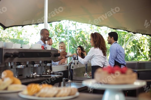 Preview: Waitress serving coffee to customer at counter
