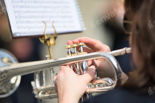 Preview: Details of woman's hands playing the trumpet
