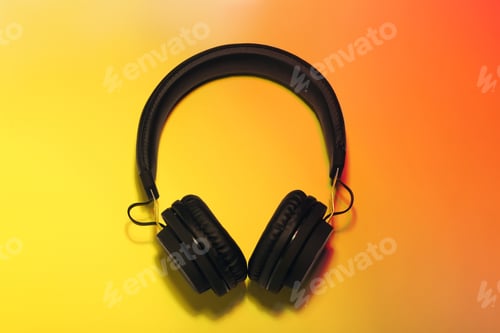 Preview: Stylish headphones on color background, top view