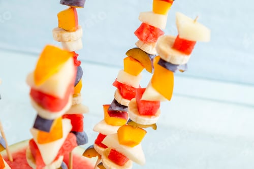 Preview: Fresh Fruit Skewers Against Light Blue Backdrop