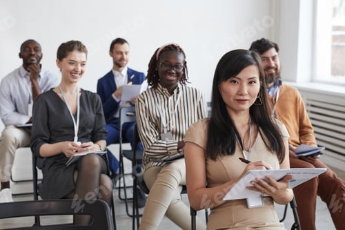 Preview: Group of Smiling Business People at Conference