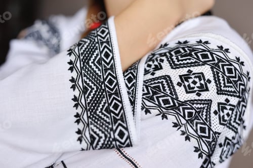 Preview: The girl in an embroidered shirt. Closeup pattern on the sleeve.