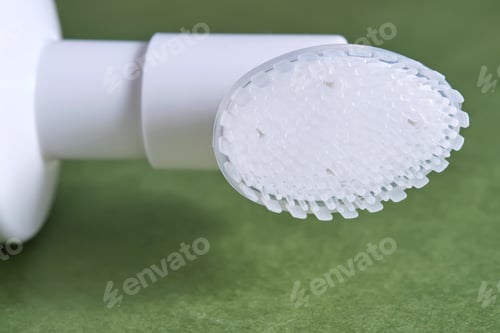 Preview: Beige facial foam with a dispenser and brush in a green background.