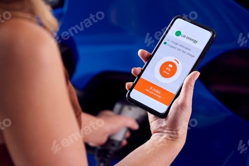 Preview: Woman Charging Electric Car With Cable Using App On Phone To Monitor Battery Level