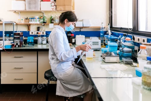 Preview: Female Scientist Working in Laboratory