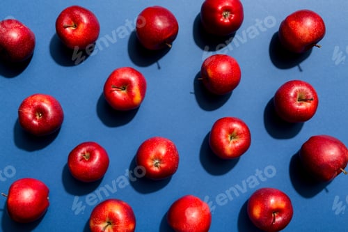 Preview: Many red apples on colored background, top view. Autumn pattern with fresh apple above view
