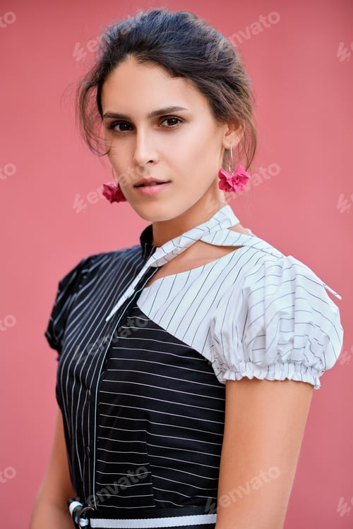 Preview: Cute fashionable lady in long striped dress descending the stairs