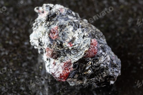 Preview: raw rock with red almandine garnets on black