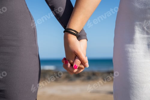 Preview: Close up of two joined female hands, concept of support between women
