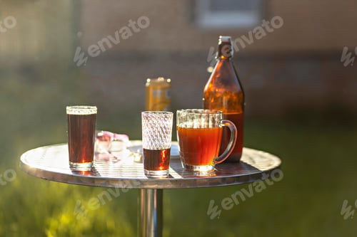 Preview: Different colored drinks on a table in the backyard of a country house