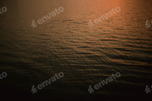 Preview: Golden Light on Water Ripples at Sunset