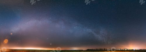 Preview: Night Starry Sky With Glowing Stars Above Countryside Landscape. Milky Way Galaxy And Rural Field