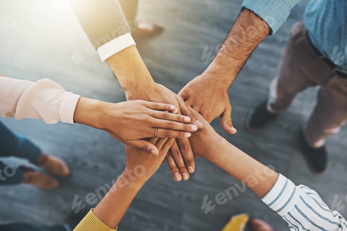 Preview: Closeup shot of an unrecognizable group of businesspeople joining their hands together in a huddle