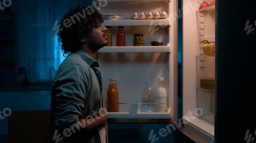 Preview: Home kitchen at night dark room hungry Hispanic man Indian male guy want eat rubbing belly open