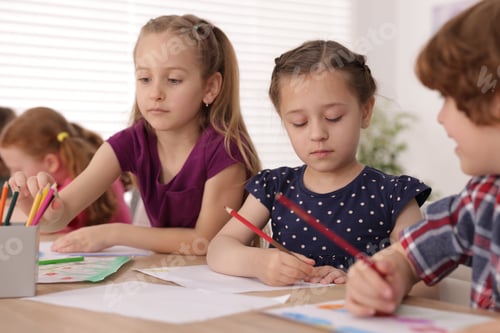 Preview: Kids painting at table indoors. Learning to draw