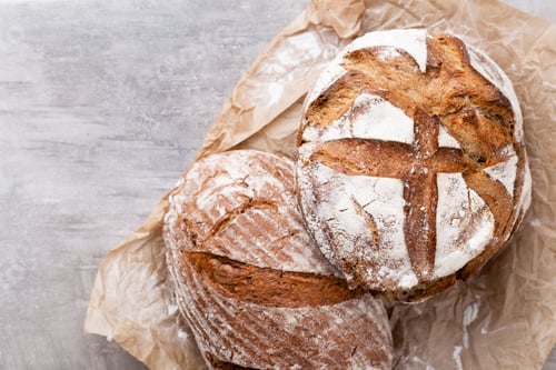 Preview: Assortment of baked bread on wooden table background.