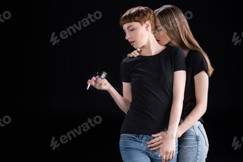 Preview: Half-length shot of young woman embracing her girlfriend from the back with her eyes closed