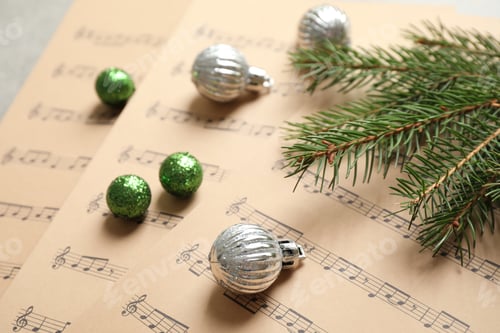 Preview: Christmas decorations on music sheets, closeup view