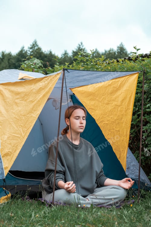 Preview: meditation Woman meditates in nature outdoor.At ground level, a relaxed woman meditates and breathes