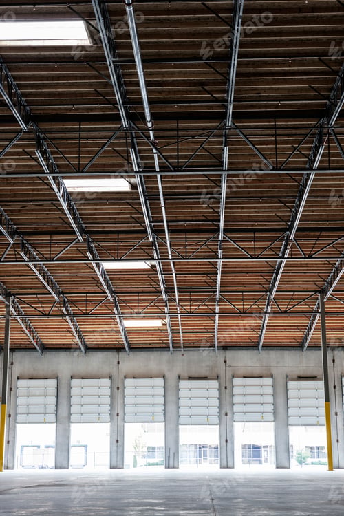 Preview: Wide angle interior view of largeempty warehouse and loading dock doors