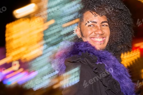Preview: Young drag queen smiling with city lights in background