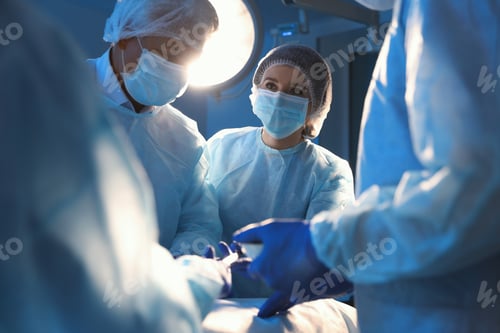 Preview: Team of professional surgeons performing operation in clinic