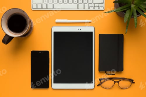 Preview: Tablet with a notebook, a pen, glasses and smartphone on a yellow background