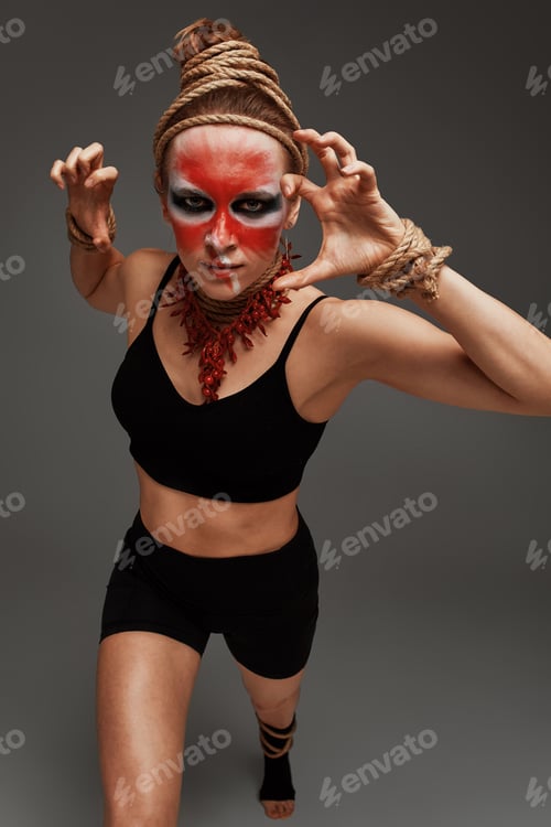 Preview: close up portrait of young beautiful girl with colorful face painting. Halloween professional makeup