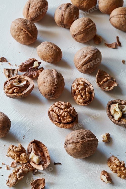 Preview: Walnuts and kernels on a white rustic backdrop