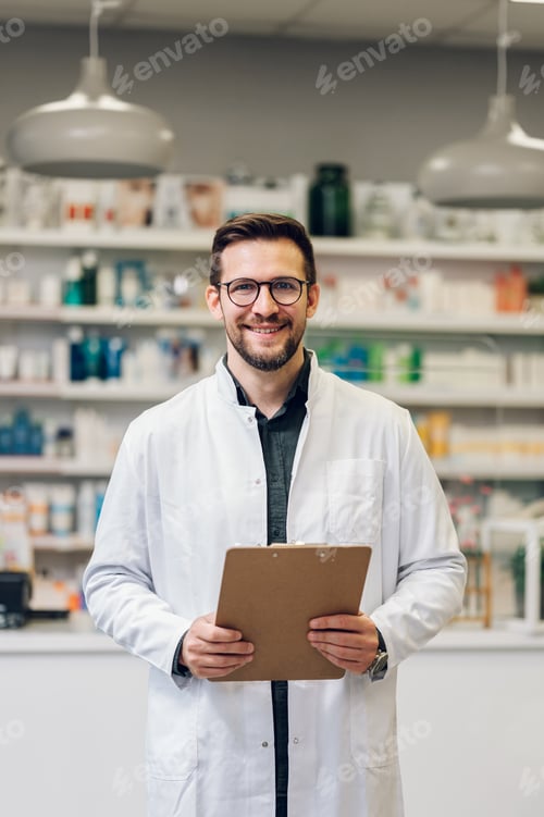 Preview: A pharmacy intern doing inventory in a drug store while smiling at the camera.