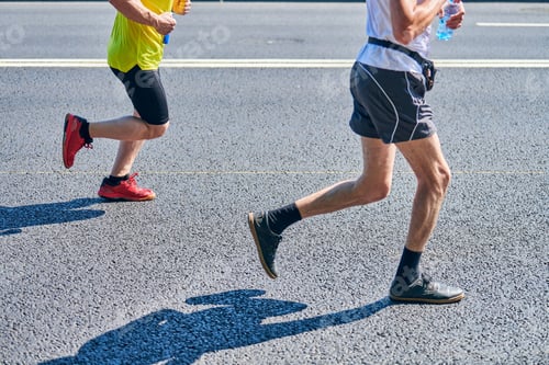 Adults Running a Race on City Street
