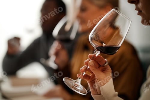 Preview: Multiethnic Group of Young Adults Tasting Red Wine during Wine Testing Event