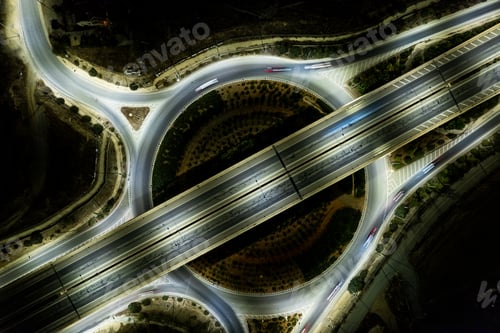 Preview: Aerial drone top view of a modern motorway junction roundabout with cars moving. Transportation