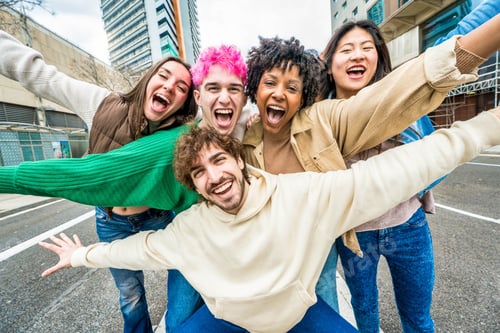 Preview: Happy multiracial friends having fun on city street