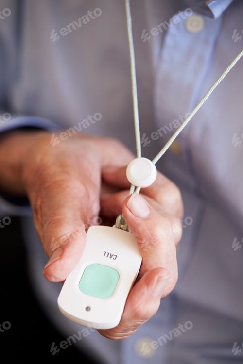 Preview: Senior Man At Home Using Distress Alarm Call Button