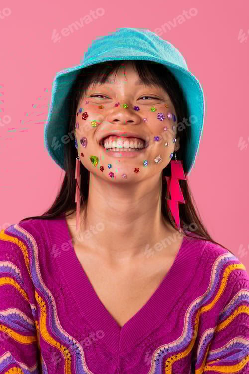 Preview: Beautiful asian woman portrait, asian woman smiling with colorful face gems and bucket hat