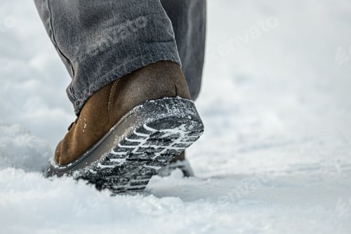 Preview: Winter boots walking on snow close up