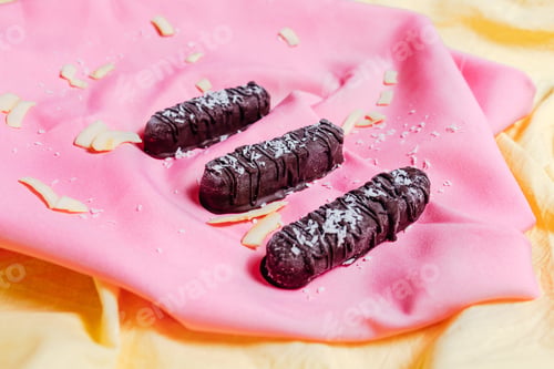 Preview: vegetarian chocolate on pink background, top view