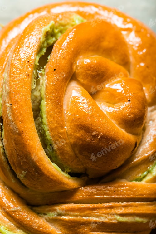 Preview: homemade buns with cream and pistachio cream decorated with thyme freshly baked for breakfast