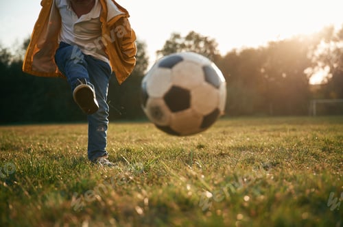 Preview: Grassy ground, with soccer ball. Little boy is playing outdoors at daytime