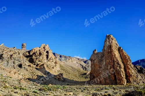 Preview: vertical rock stone formations on a bright sky sunny day