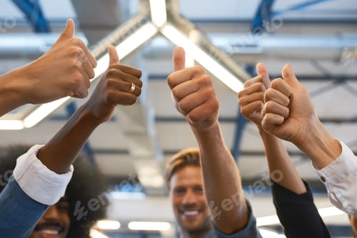 Preview: Cropped shot of a group of designers giving you the thumbs up in their office