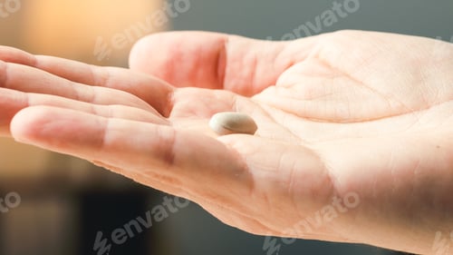 Preview: Withe pills on hand