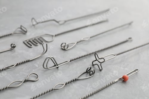 Preview: Set of different logopedic probes on marble table. Speech therapist's tools