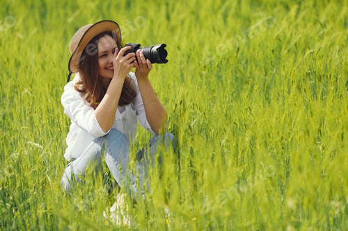 Preview: Woman shooting in a summer field