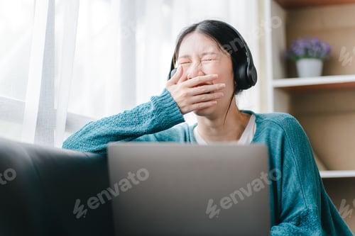 Preview: Smart and positive Asian female freelancer or female college student sitting on sofa with laptop. St