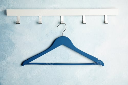 Preview: Rack with empty clothes hanger on color wall. Wardrobe accessory