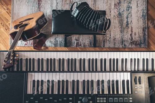 Preview: Piano keys, acoustic guitar, top view, musician's workplace.